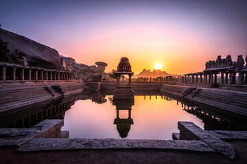 Wall Mural - View of sunrise at Pushkarni, Sri Krishna tank in ruins. Hampi, karnataka, India.