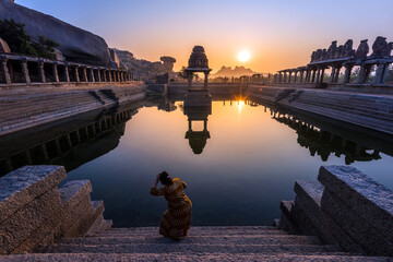 Wall Mural - View of sunrise at Pushkarni, Sri Krishna tank in ruins. Hampi, karnataka, India.