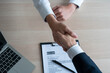 Businessmen and job seekers shake hands after agreeing to accept a job and approve it as an employee in the company. Or a joint venture agreement between the two businessmen