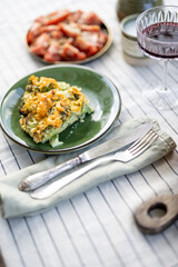 Wall Mural - A piece of cheese pie on green plate on table covered with a tablecloth. Summer dinner outdoor. 