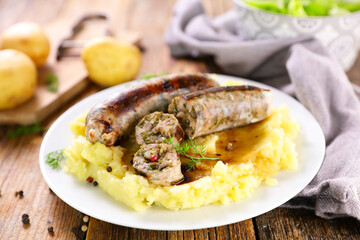 plate of mashed potato with sausage