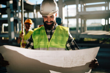 Successful construction site manager engineer working at construction site