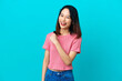© luismolinero - Young Vietnamese woman isolated on blue background celebrating a victory