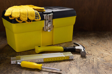 Construction tools and toolbox on wooden tablel background texture. Tool box