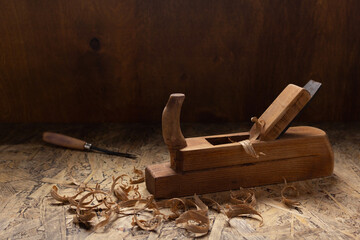 Woodworking tools on wooden table. Plane jointer carpenter or joiner tool and wooden shavings