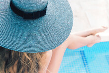 Slim Anonymous Woman In Bikini Sitting At Poolside In Tropical Resort