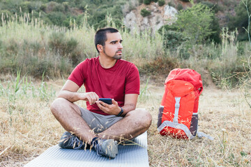 Wall Mural - Hiker camping and using mobile. Camping concept.