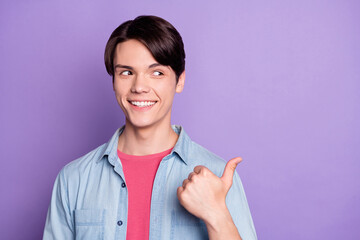 Sticker - Photo of young man happy positive smile indicate thumb empty space recommend promo isolated over purple color background