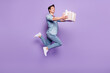 Full body profile side photo of young guy happy smile guest give present box jump isolated over purple color background