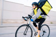 © ADDICTIVE STOCK - Delivery woman riding bicycle on street