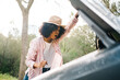 © ADDICTIVE STOCK - Shocked woman looking under car hood in nature