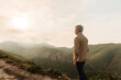 © ADDICTIVE STOCK - Senior woman traveler in mountains at sunrise
