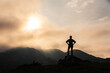 © ADDICTIVE STOCK - Unrecognizable traveler in mountains at sunrise