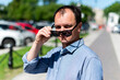 © gesrey - Caucasian man forty years old businessman on the street takes off his sunglasses
