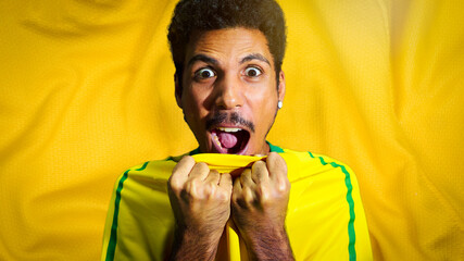 Wall Mural - Male black athlete with uniform smiling. Sportsman isolated in a colored fabcric background. Space for text.