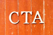 Alphabet Letter In Word CTA (Abbreviation Of Call To Action Or Chartered Tax Adviser) On Old Red Color Wood Plate Background