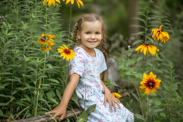 Portrait of a beautiful little girl in the summer in the park.
