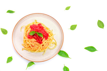 Wall Mural - Spaghetti or pasta with tomato sauce and fresh green basil on a white plate isolated on a white background - top view