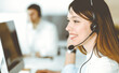 © Iryna - Group of diverse operators at work in call center. Beautiful asian woman sitting in headset at customer service office. Business concept