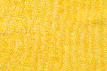 Clothing fabric yellow texture background, close up of cloth textile surface abstract.