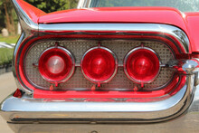 The Red Round Tail Light Of A Classic Red Vintage Car.