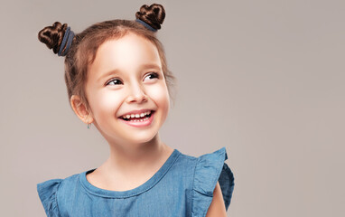 Portrait of beautiful little girl. Joy, postive emotions and happy childhood concept. Beautiful adorable baby in blue dress