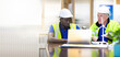 © NVB Stocker - Two engineers African american engineer and caucasian electrician wearing white hard hat working on laptop computer at workplace office. clean and green alternative energy concept.