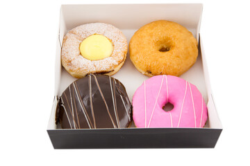 Cream chocolate and strewberry donut in the box, close up isolated on white