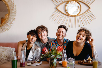 circle of friends smiling cheerfully in a restaurant