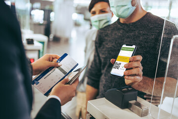 Traveler using vaccine passport for checking in at airport