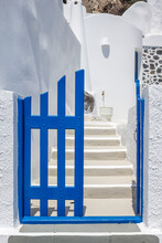 Entrance To A Traditional Greek Island Home With A Blue Gate And Whitewashed Steps And Walls