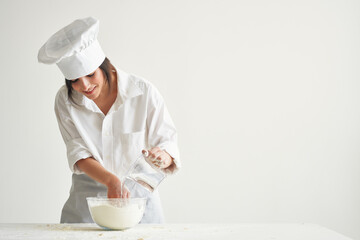 Wall Mural - woman chef kneading dough working with flour Professional