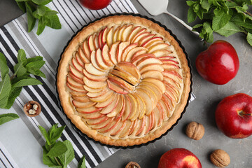 Wall Mural - Flat lay composition with delicious homemade apple tart on grey table