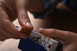 © New Africa - Woman taking cigarette out of pack at table, closeup