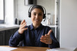 © fizkes - Happy funny Indian student wearing headphones and microphone looking at webcam, smiling at camera, laughing during virtual meeting or video call talk. Employee working from home. Screen view head shot