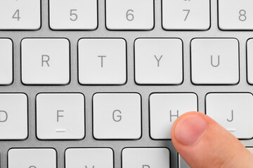 Top view of man pressing button on computer keyboard, closeup