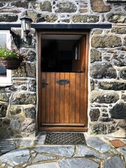 Half open wooden stable door to stone cottage