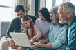 © gstockstudio - Carefree family spending time together and smiling while sitting on the sofa at home