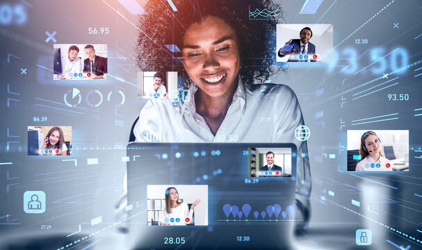 Attractive African American businesswoman using laptop to be a part of video conference call, business colleagues, a team communicating on the distance, hologram digital interface