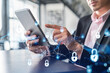 © VideoFlow - Businessman in suit checking cyber security using tablet device to protect clients confidential information. IT hologram lock icons over modern panoramic office background.