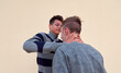 © Érik Glez. - A young male aggressively bully choking another male