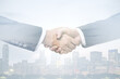 © Pixels Hunter - Multi exposure of handshake of two businessmen on city skyscrapers background, collaboration and teamwork concept