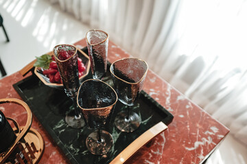 An elegant set of glasses and wine glasses placed on a tray