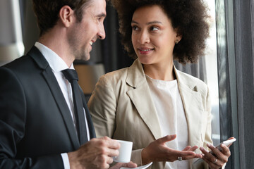 Sticker - Young couple of professionals chatting during a coffee break