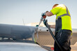 Mechanic fills a plane with fuel preparing for flight