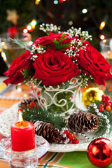 Wall Mural - Christmas arrangement with red roses, pine cones and winter berries. Christmas table setting
