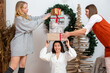 © ako-photography - young females having fun wrapping gifts at home, great teamwork of friends packing presents for christmas