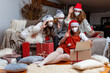 © ako-photography - group of women wearing Christmas hats and protective face masks, take video calls during coronavirus