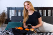 © ako-photography - young blonde woman having breakfast in bed, drinking coffee and eating fruit