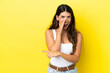 © luismolinero - Young caucasian woman isolated on yellow background pointing to the side to present a product and whispering something